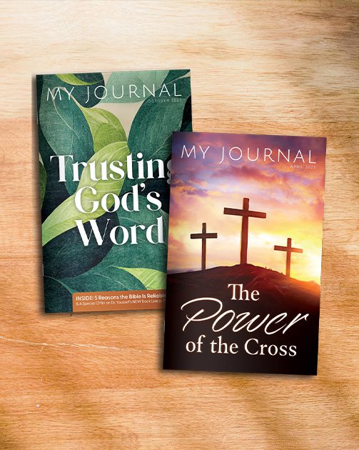 overhead photo of 2 books laying on a wood table: 