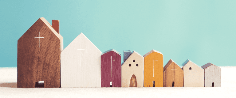 Small wooden figures of churches, lined up