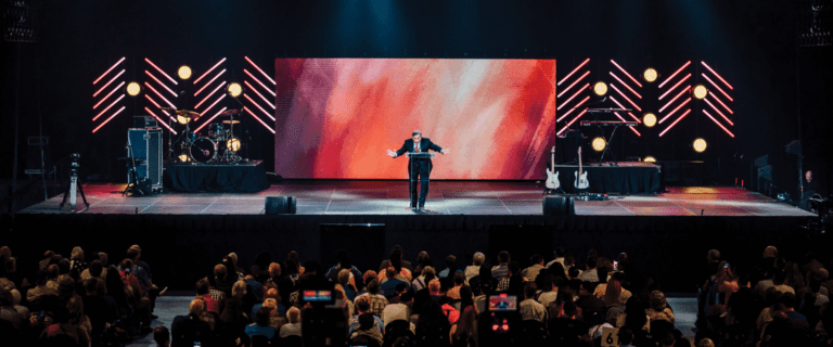 Dr. Youssef preaches in front of a crowd