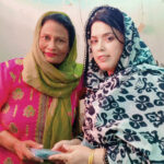 Two women with Navigator in their hand